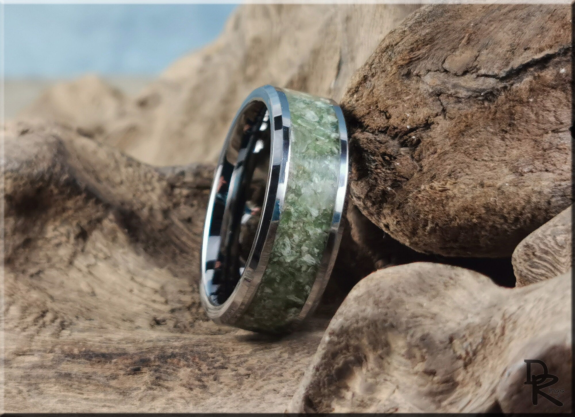 DR Rings tungsten ring with jade inlay placed on textured natural wood background
