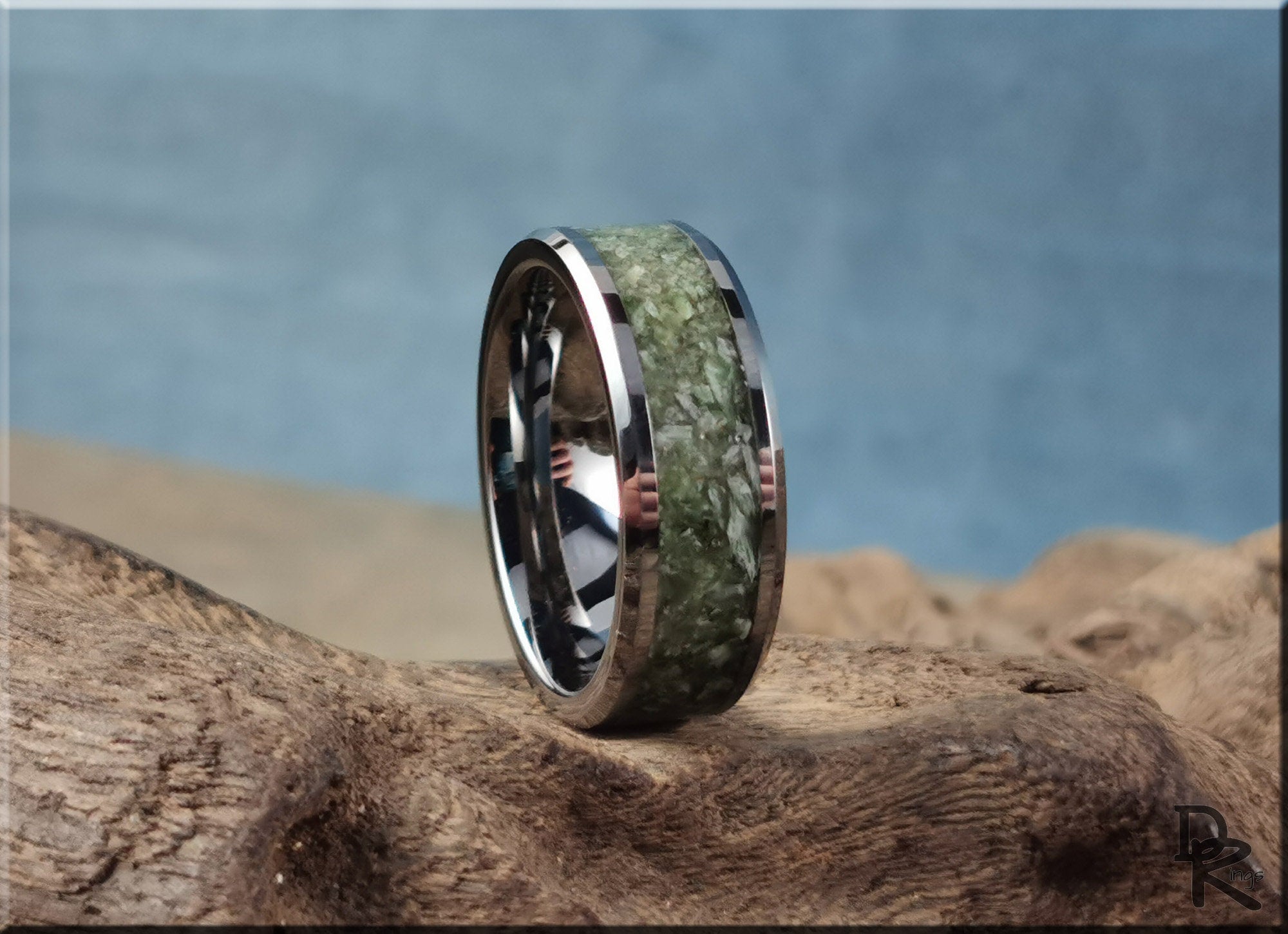 DR Rings tungsten ring with jade inlay featuring polished silver edges on natural wood surface