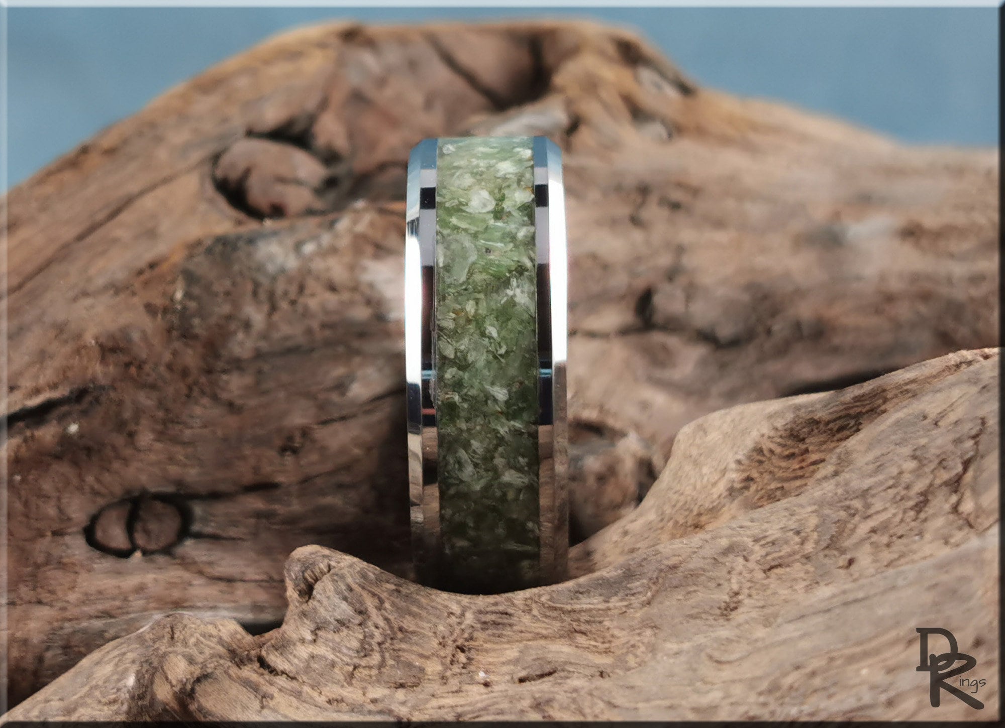 Tungsten ring with jade inlay set against rustic wooden background by DR Rings