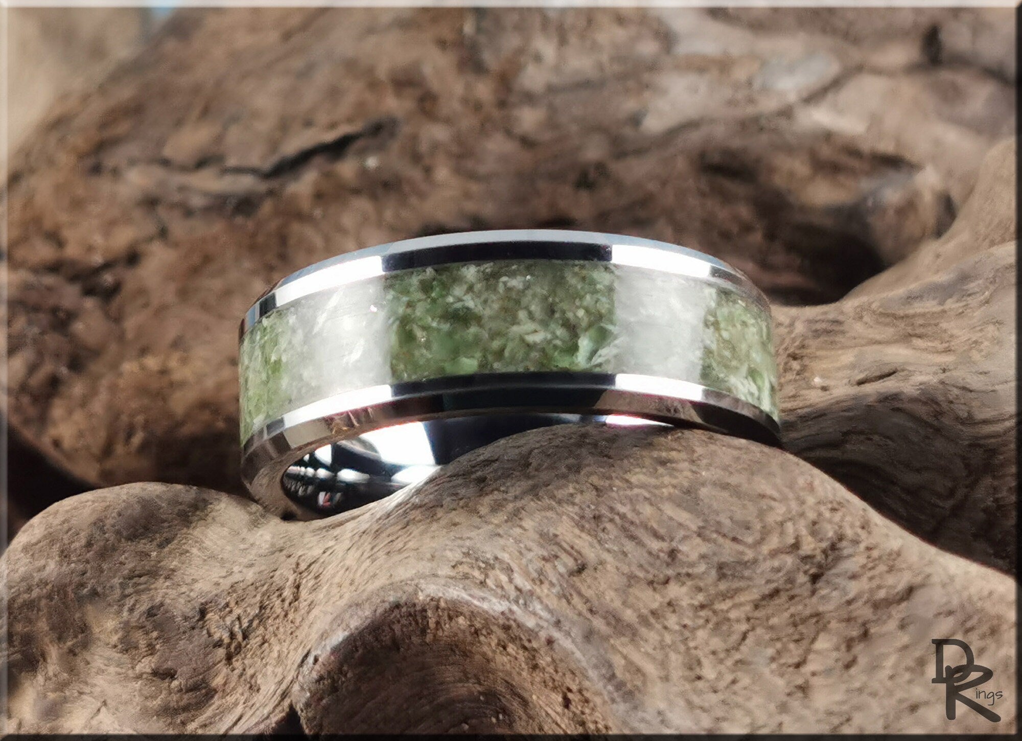 DR Rings tungsten ring with jade inlay featuring polished silver edges on natural wood background