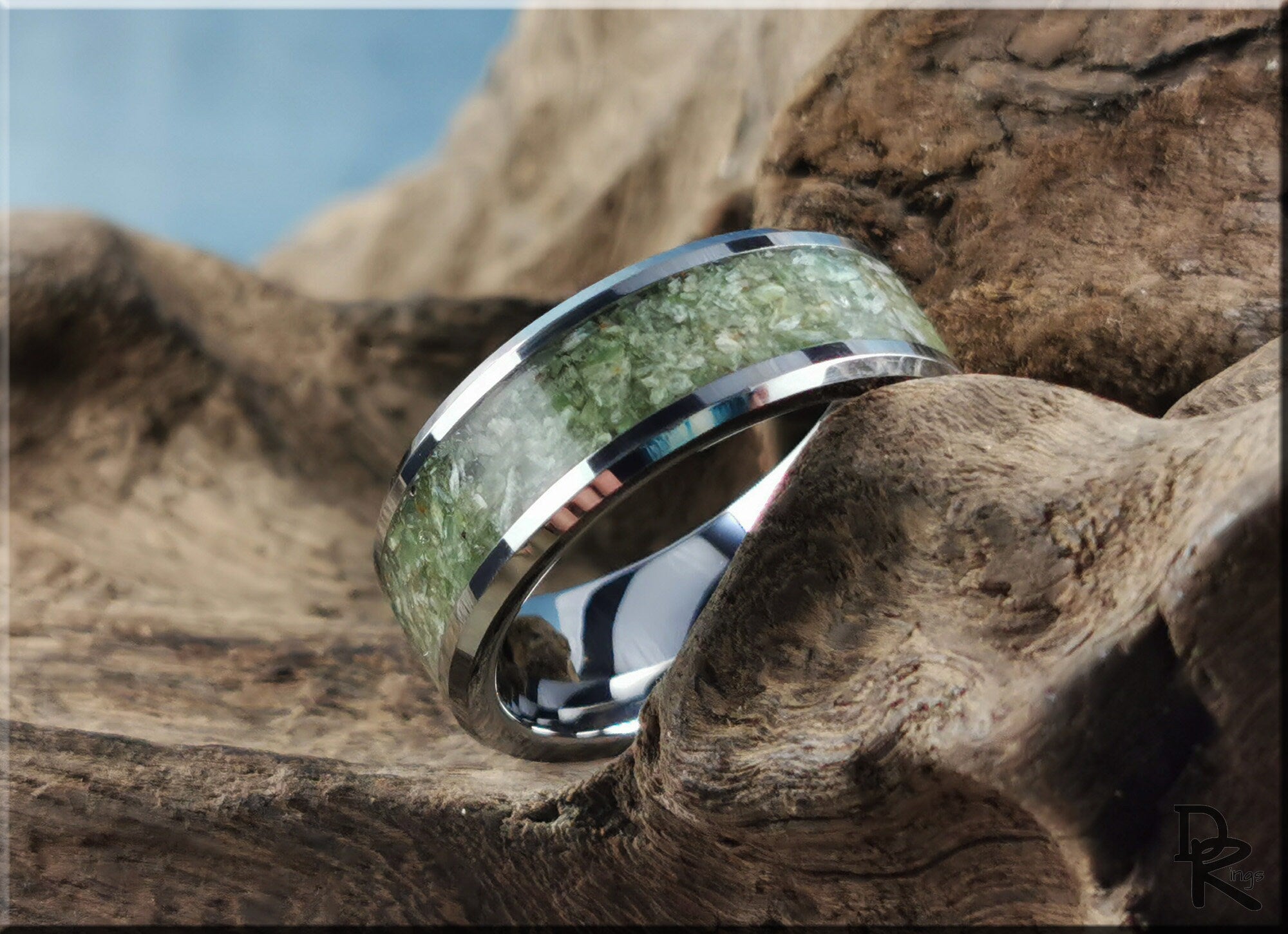 DR Rings tungsten ring with jade inlay resting on textured wood background