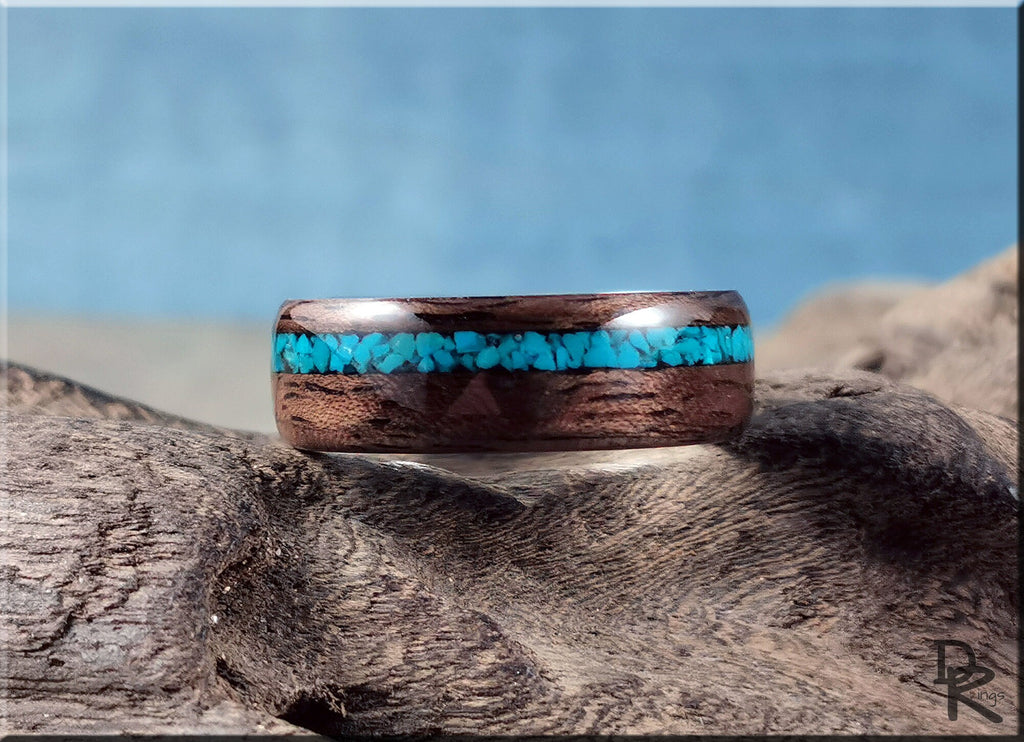 Walnut ring with turquoise inlay on textured natural wood background by DR Rings