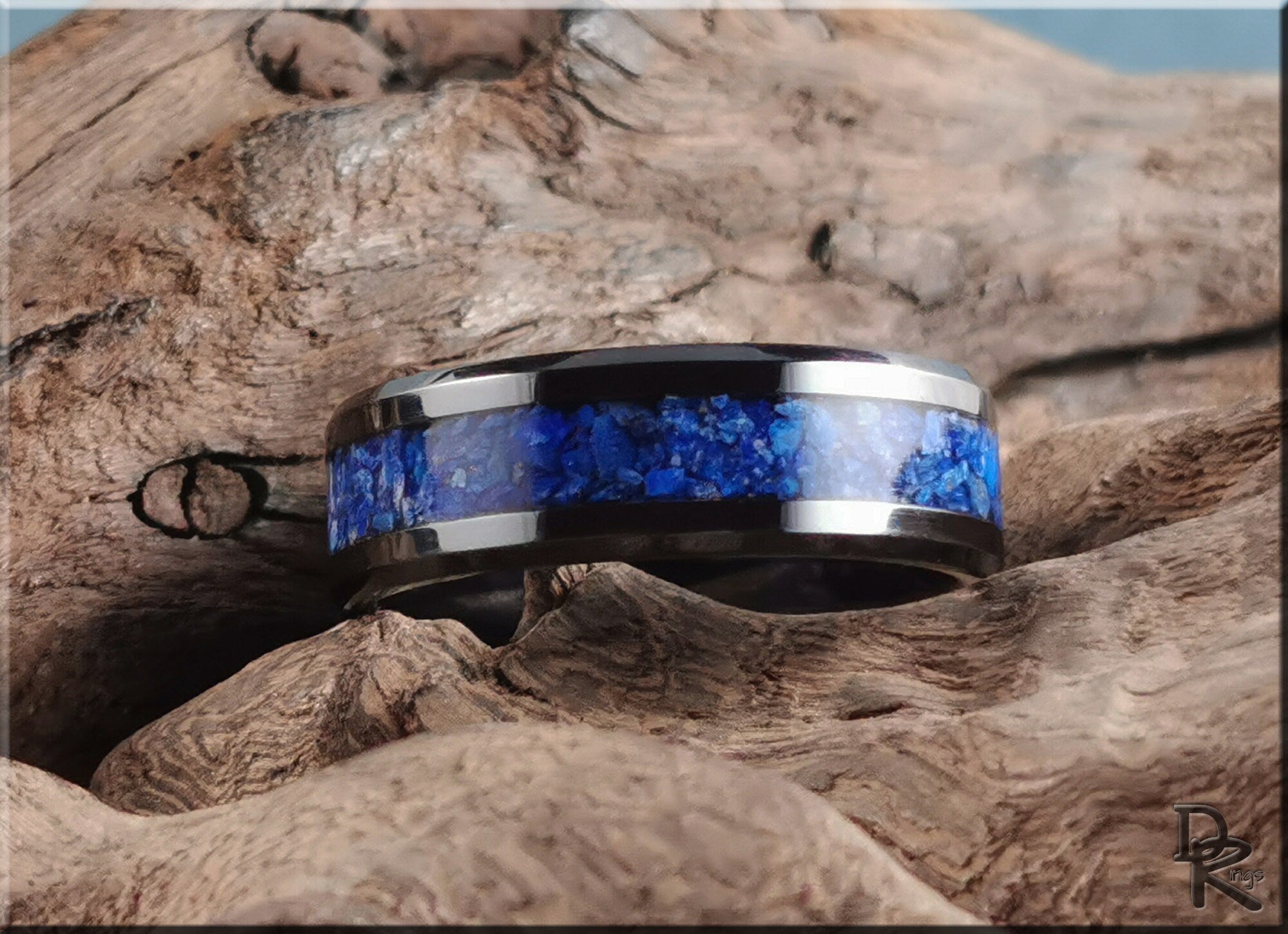 Ceramic ring with lapis blue stone inlay set on natural wood background by DR Rings