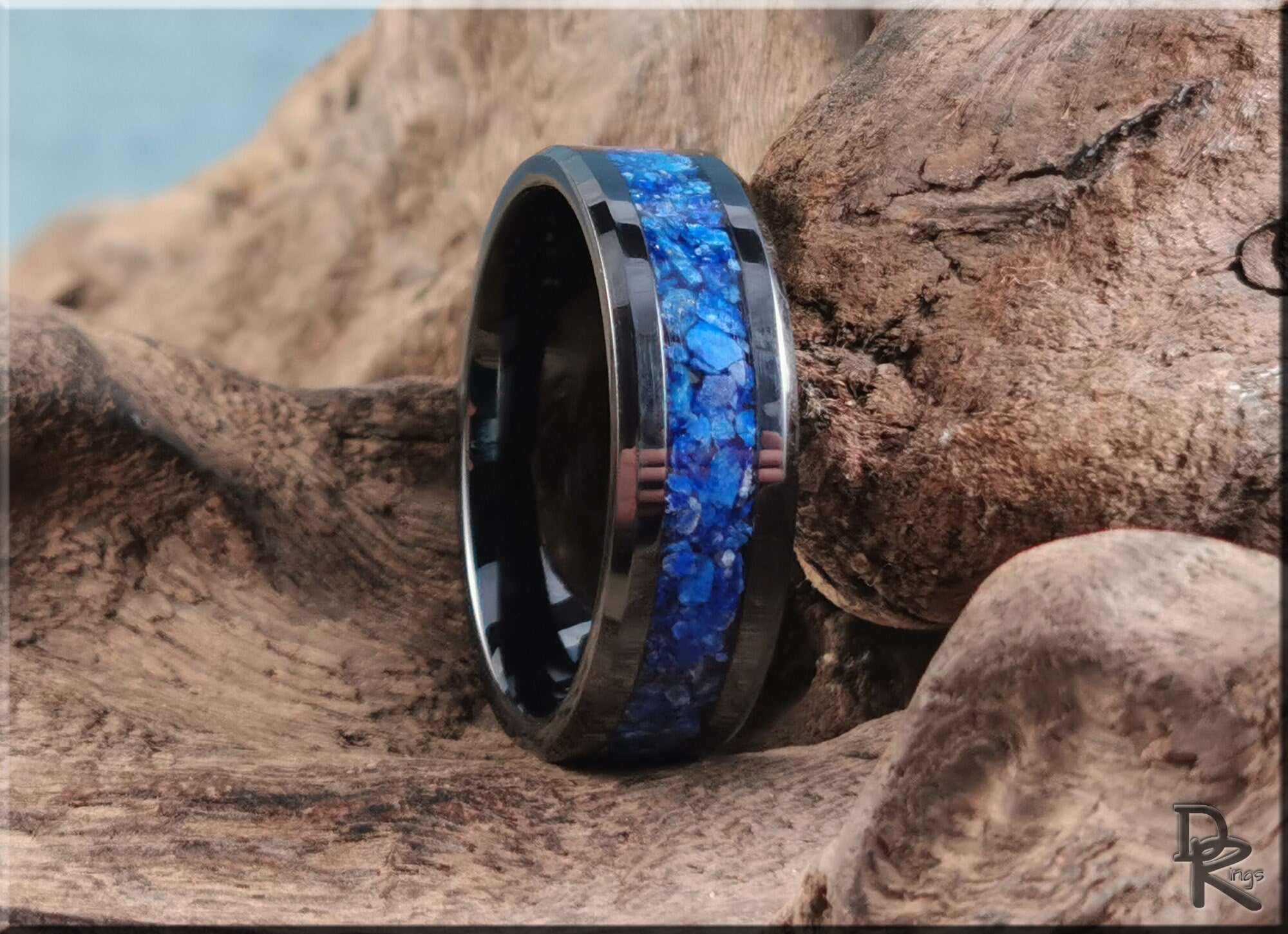 Ceramic ring with lapis blue stone inlay on a rustic wooden background by DR Rings