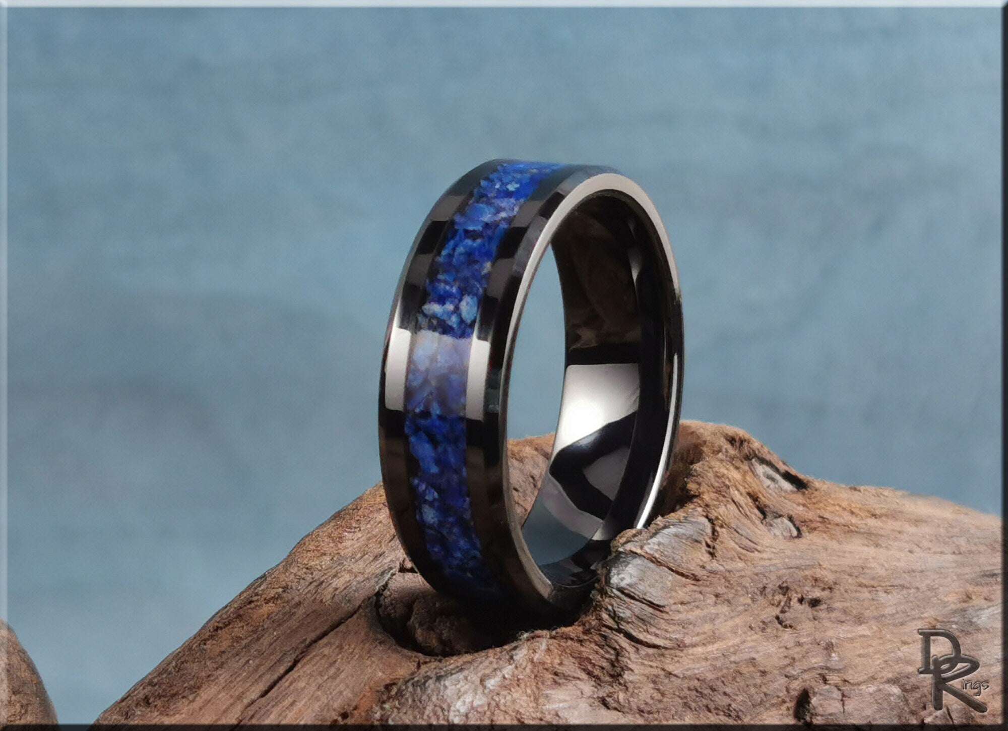 Ceramic ring with lapis blue stone inlay showcased on a wooden surface by DR Rings