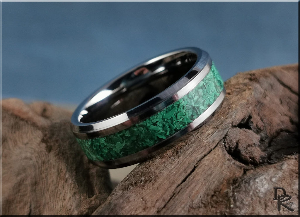 Tungsten ring with green malachite inlay on rustic wooden surface by DR Rings