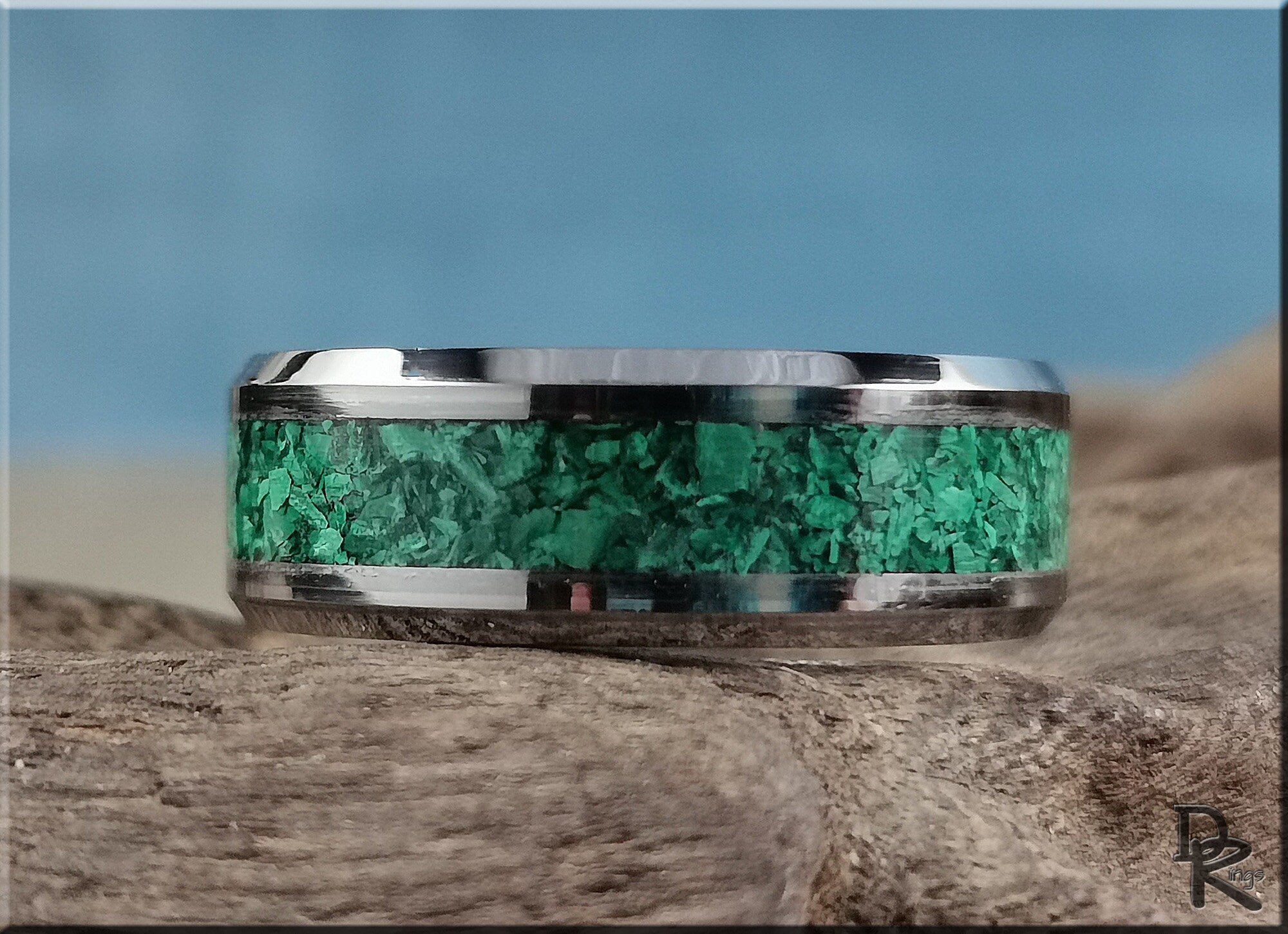 Tungsten ring with green malachite inlay by DR Rings displayed on natural wood background