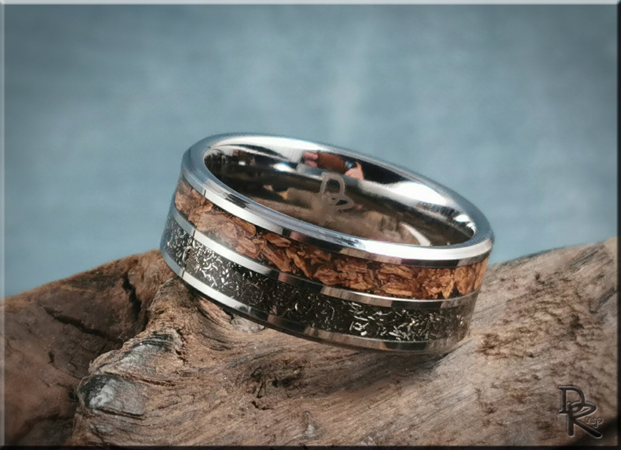 DR Rings tungsten ring with inlays featuring wood and black textured design on wood background