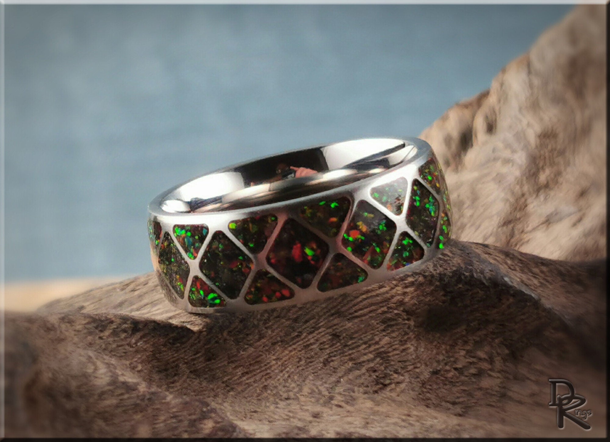 DR Rings titanium ring with opal inlay featuring a geometric pattern and iridescent green opal stones