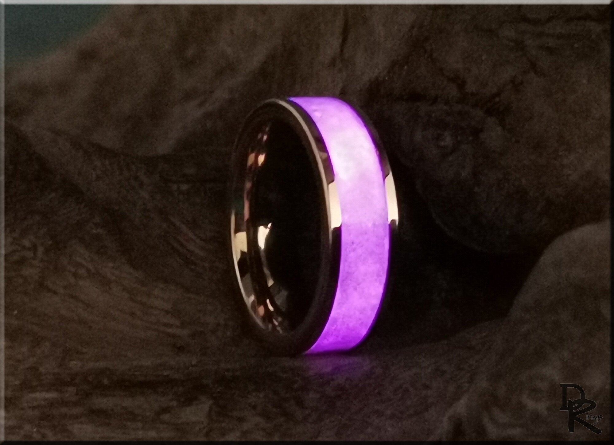 Rose tungsten ring with glow inlay glowing purple on dark textured background