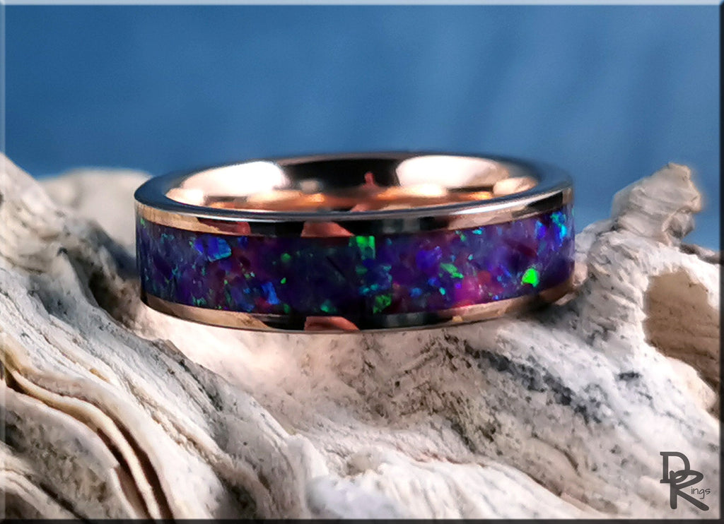 Rose tungsten ring with opal inlay featuring vibrant blue and green opal stones in a polished rose gold band