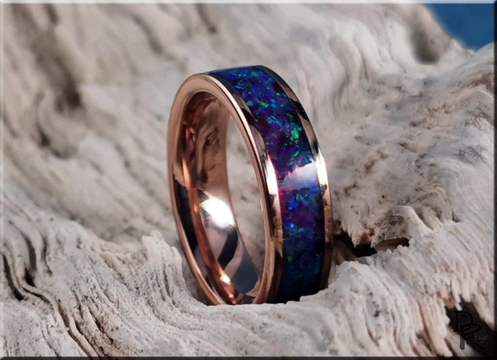 Rose tungsten ring with opal inlay featuring vibrant blue and green opal set in polished rose gold band