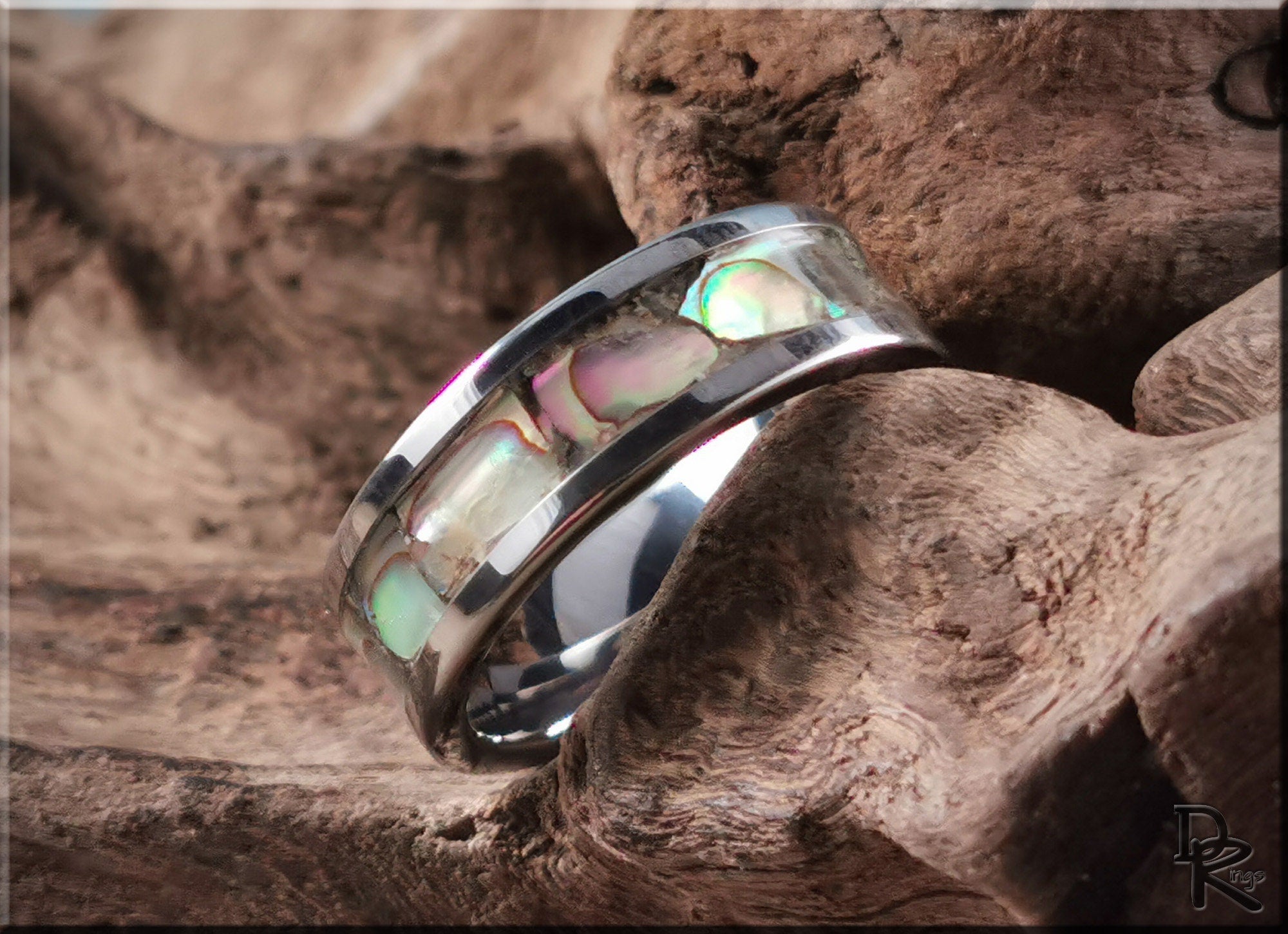 DR Rings super titanium ring with iridescent inlay on rustic wood background