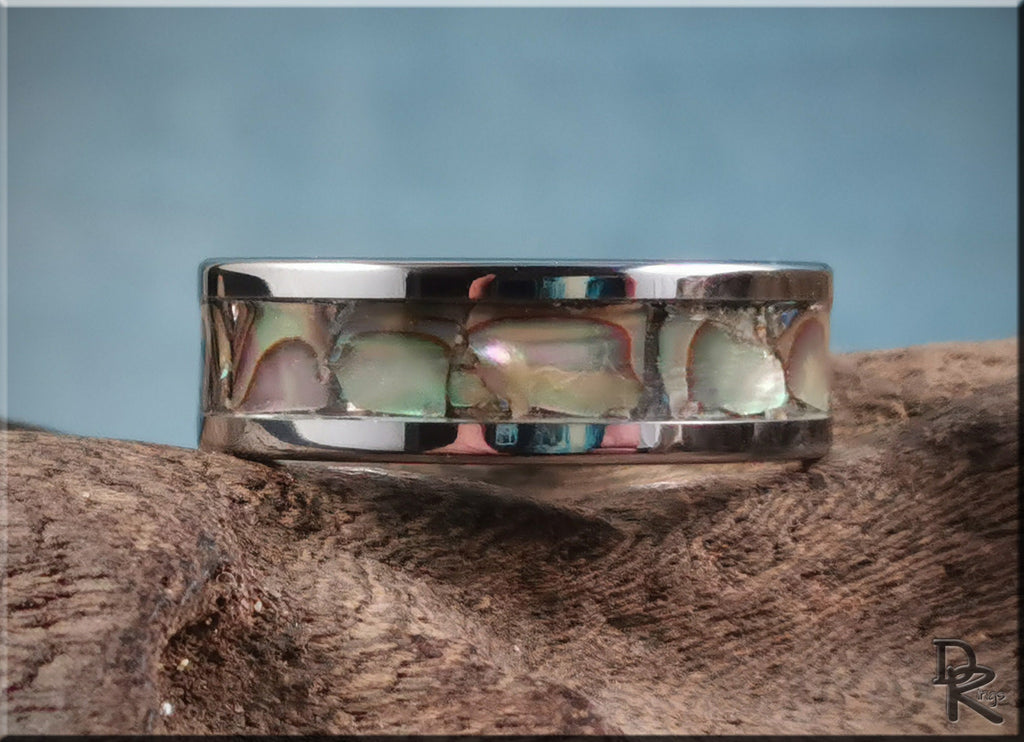 DR Rings super titanium ring with polished silver band and colorful inlay on rustic wood background