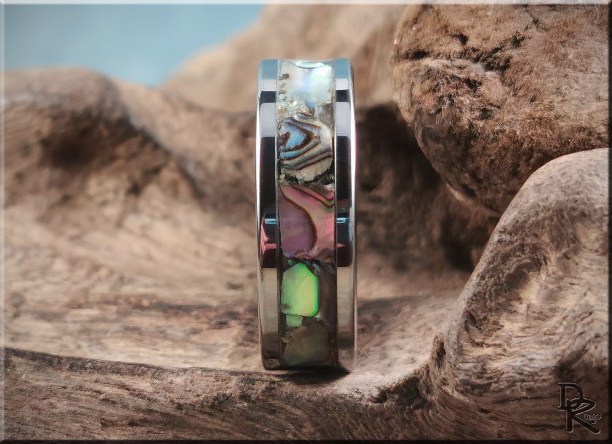 DR Rings super titanium ring with colorful inlay on natural wooden background