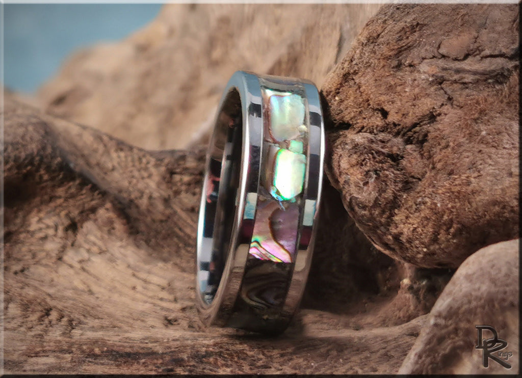 DR Rings super titanium ring with iridescent inlay on natural wooden background