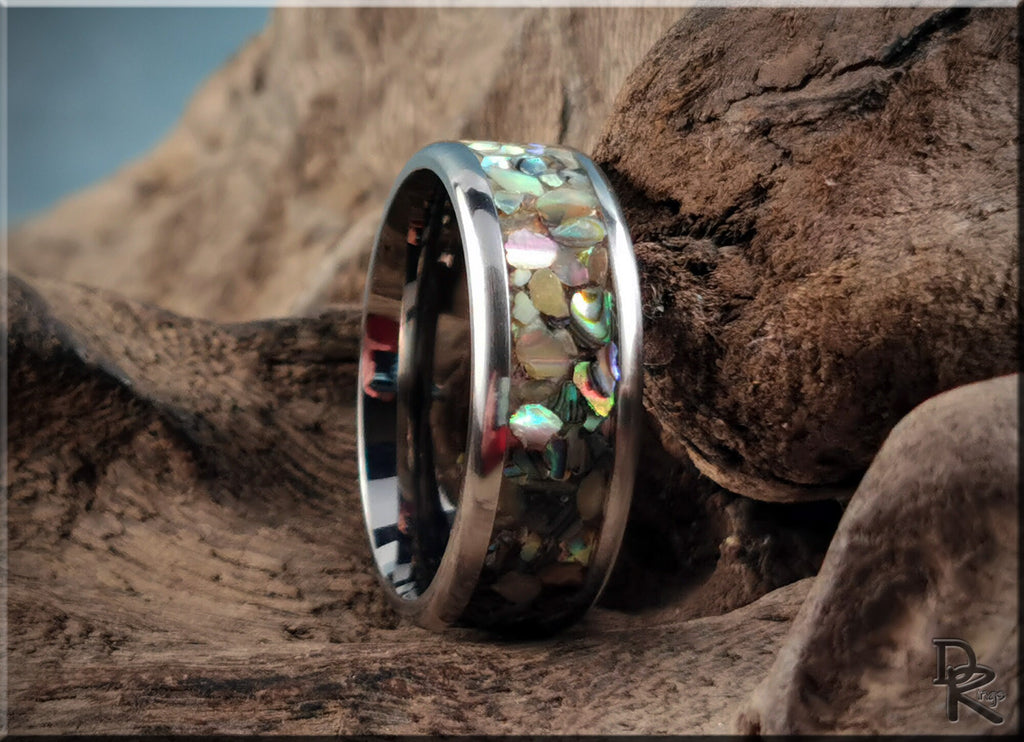 DR Rings titanium ring with abalone inlay showcasing iridescent shell patterns on a polished band