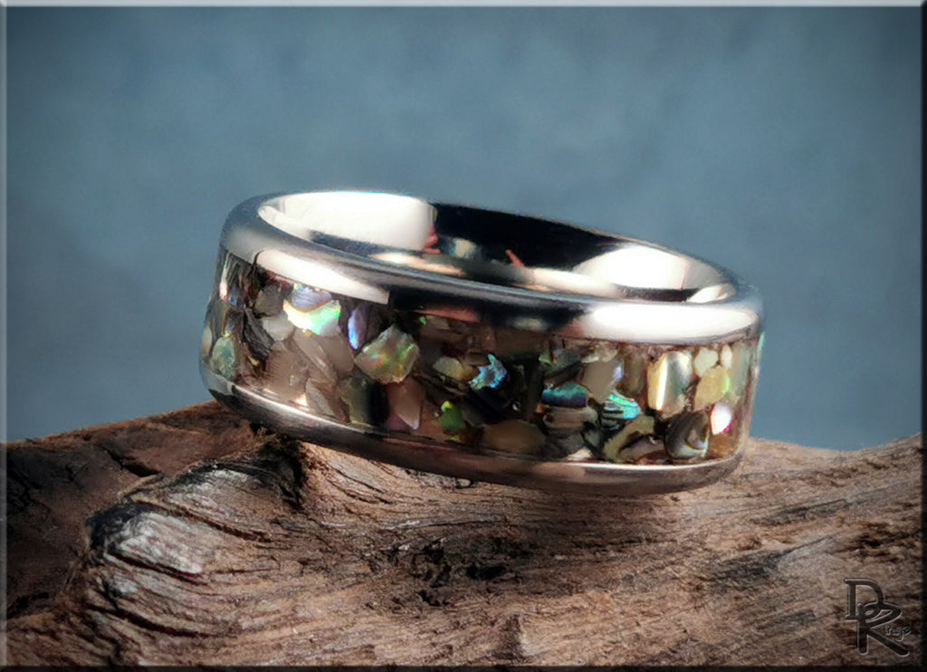 DR Rings titanium ring with abalone inlay featuring iridescent shell pieces on a polished band