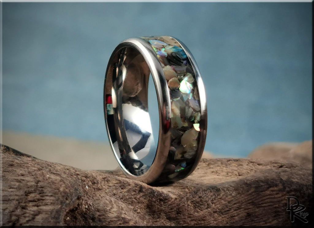 DR Rings titanium ring with abalone inlay featuring a polished silver finish on natural wood background