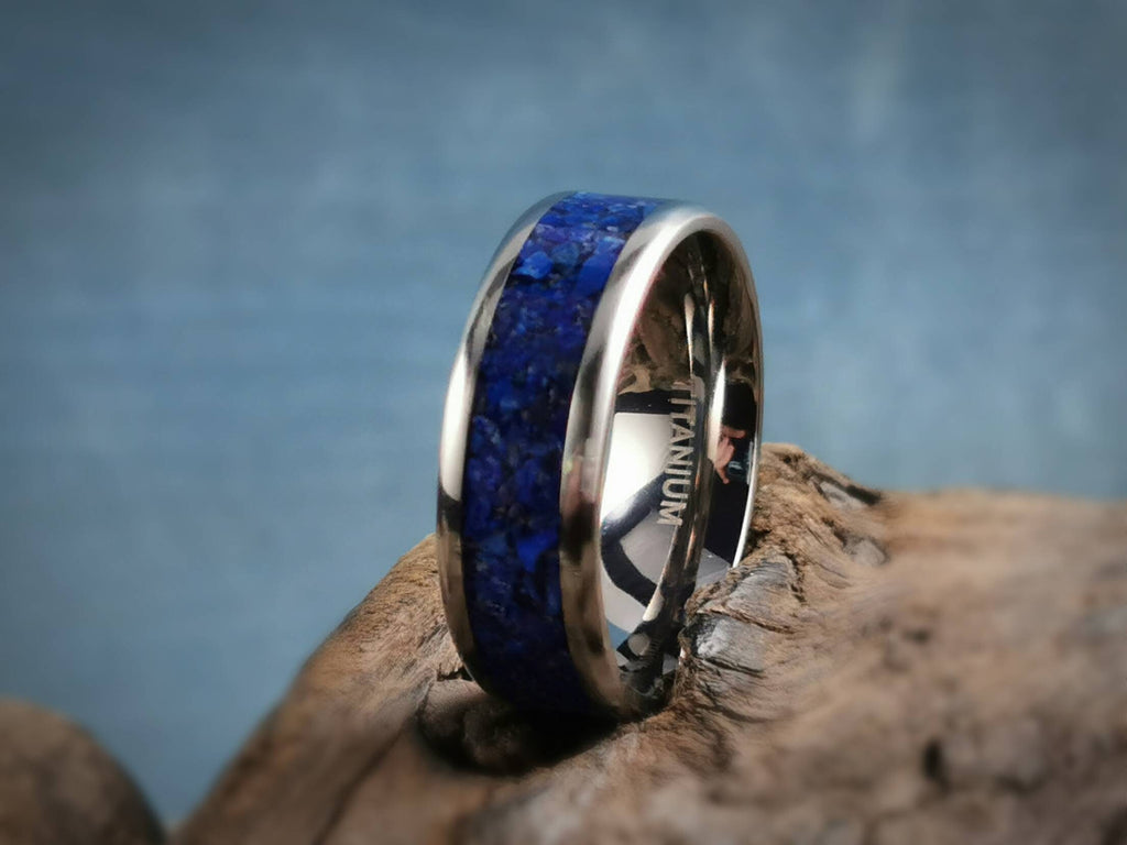 Titanium ring with lapis blue stone inlay from DR Rings displayed on rustic wood background