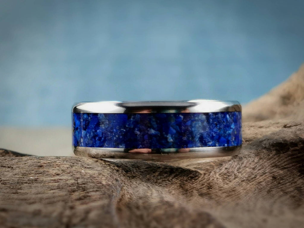 DR Rings titanium ring with lapis blue stone inlay on natural wooden surface