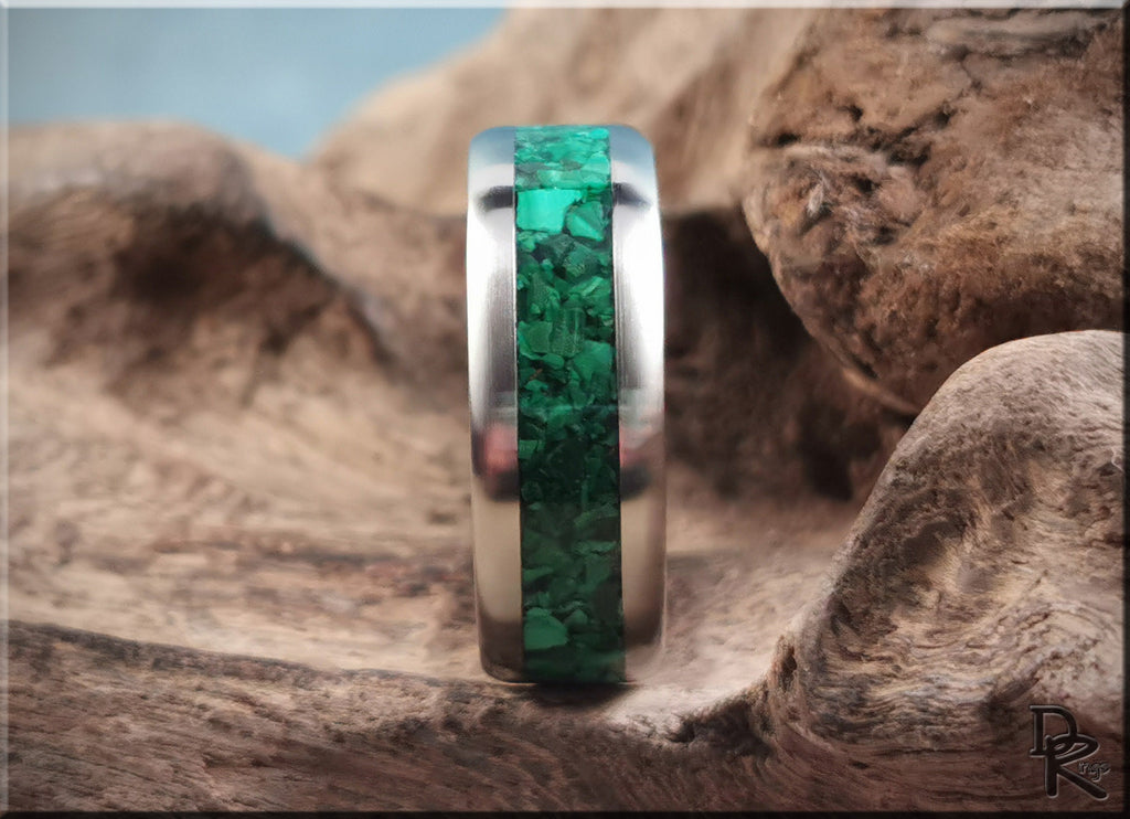 DR Rings titanium ring with malachite inlay displayed on natural wood background