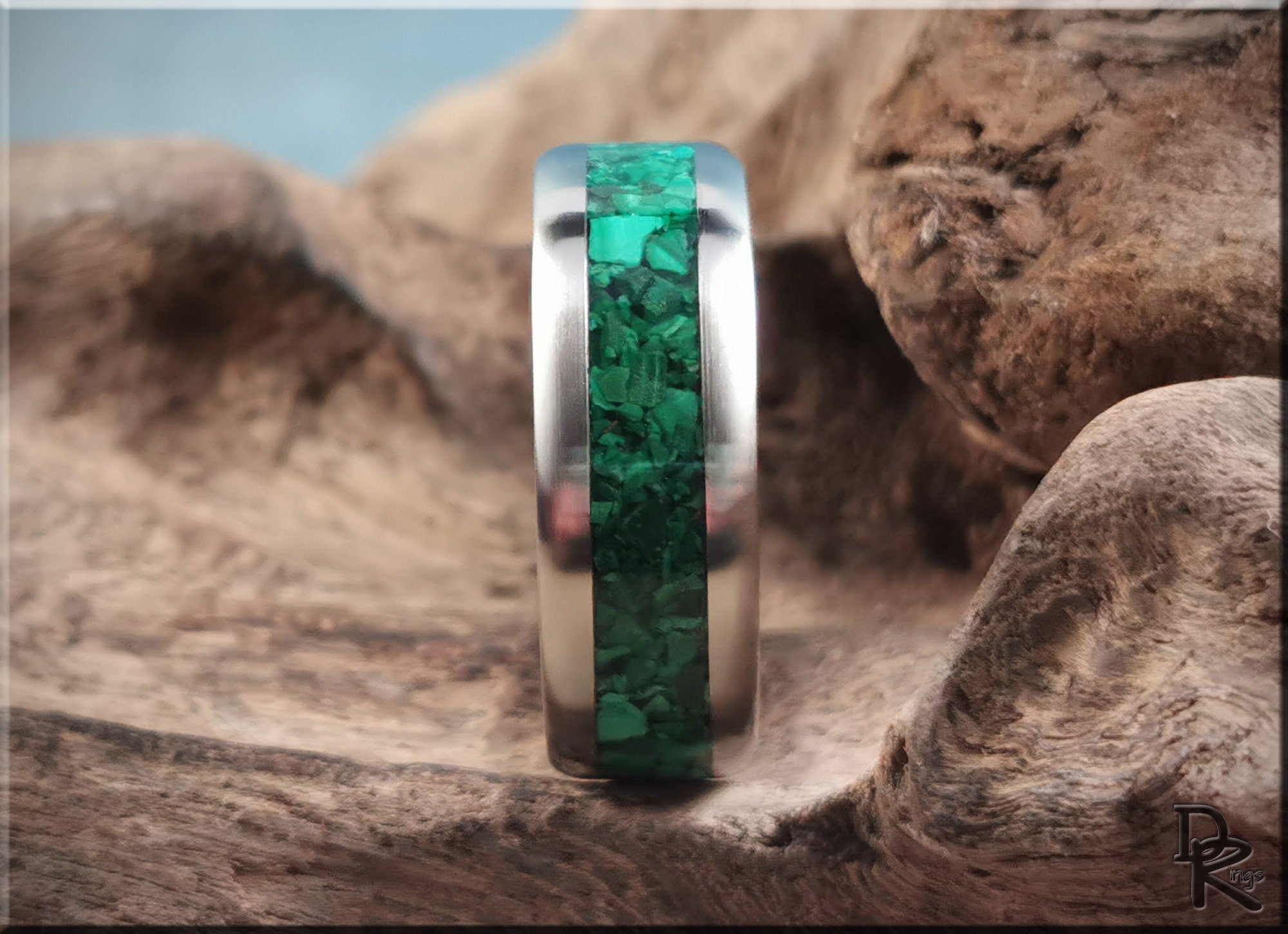 DR Rings titanium ring with malachite inlay displayed on natural wood background