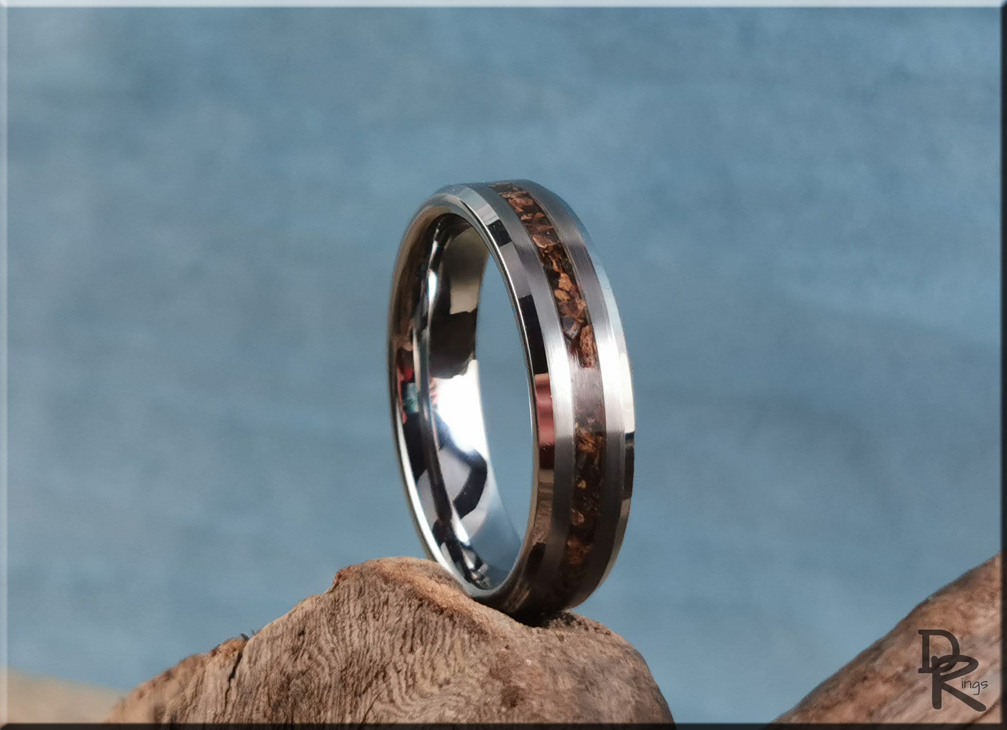 Tungsten carbide ring with inlay featuring a wood grain design on a polished silver band