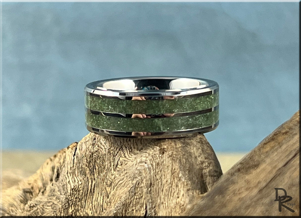 DR Rings tungsten ring carbide with emerald inlay featuring a polished silver finish on textured wood