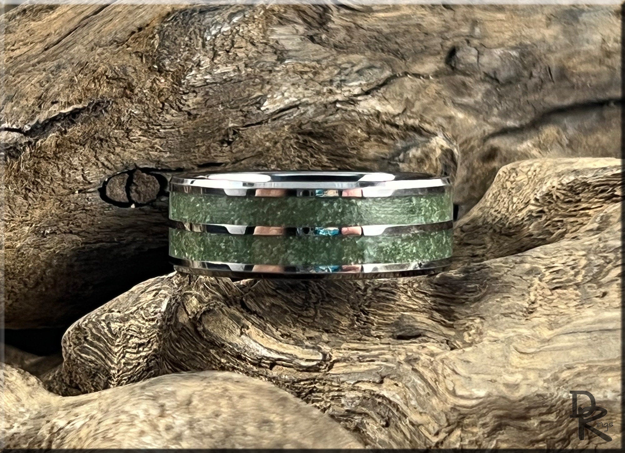DR Rings tungsten ring carbide with emerald inlay on textured wooden background