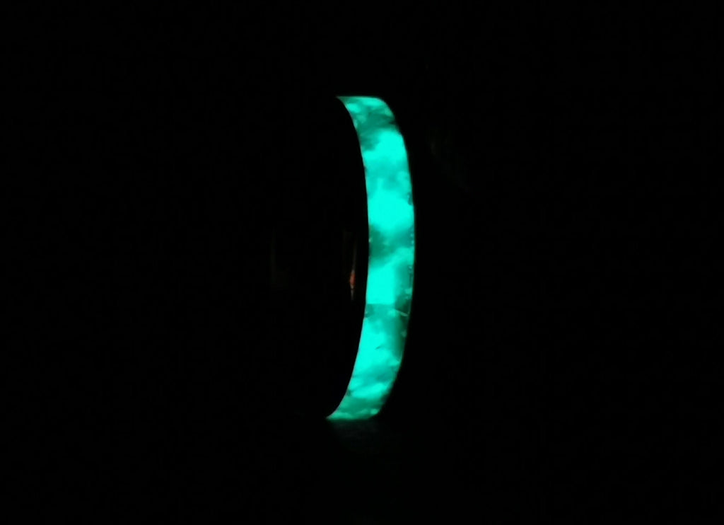 DR Rings tungsten ring with opal and glow glowing bright blue in dark background