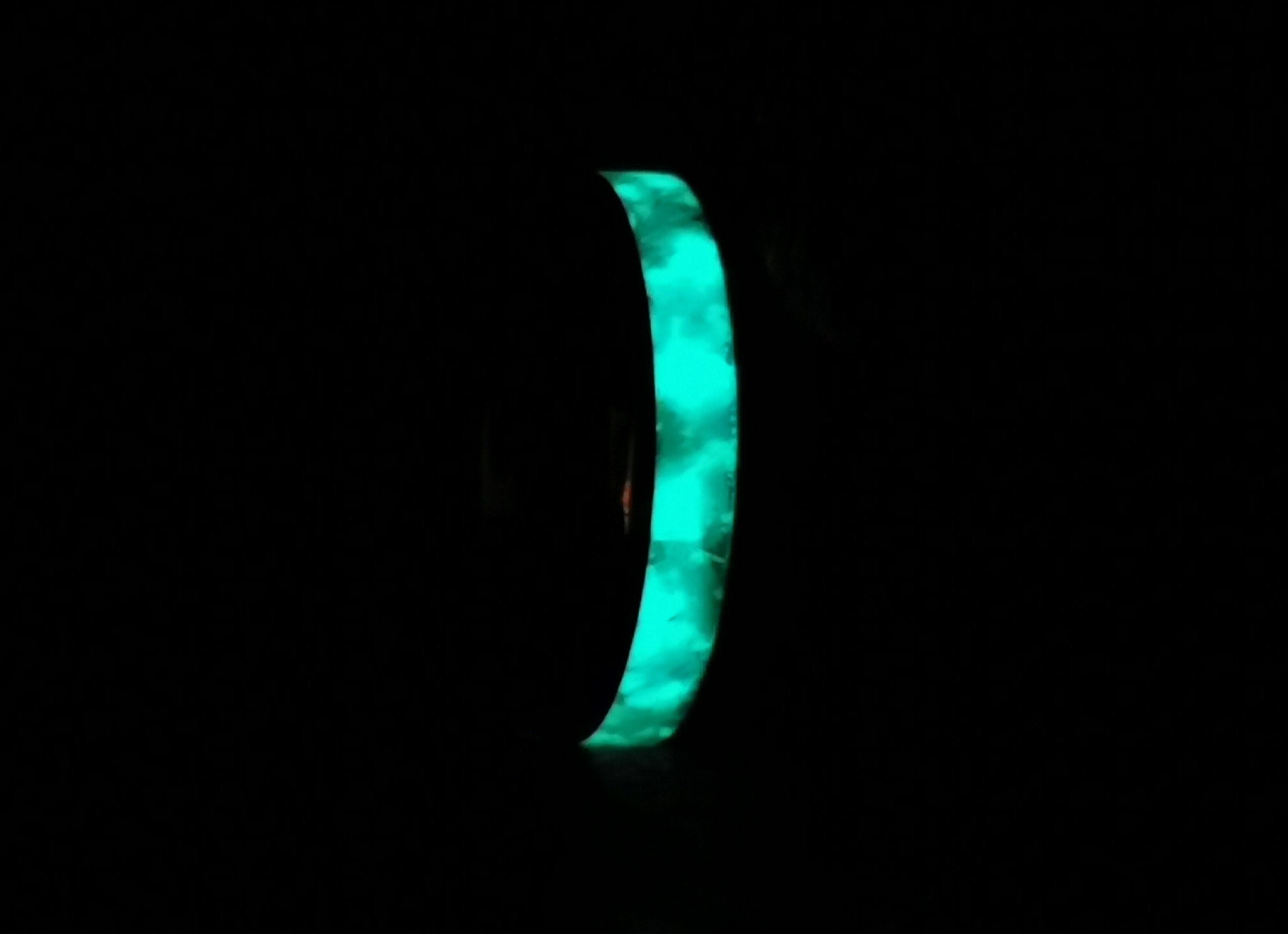 DR Rings tungsten ring with opal and glow glowing bright blue in dark background