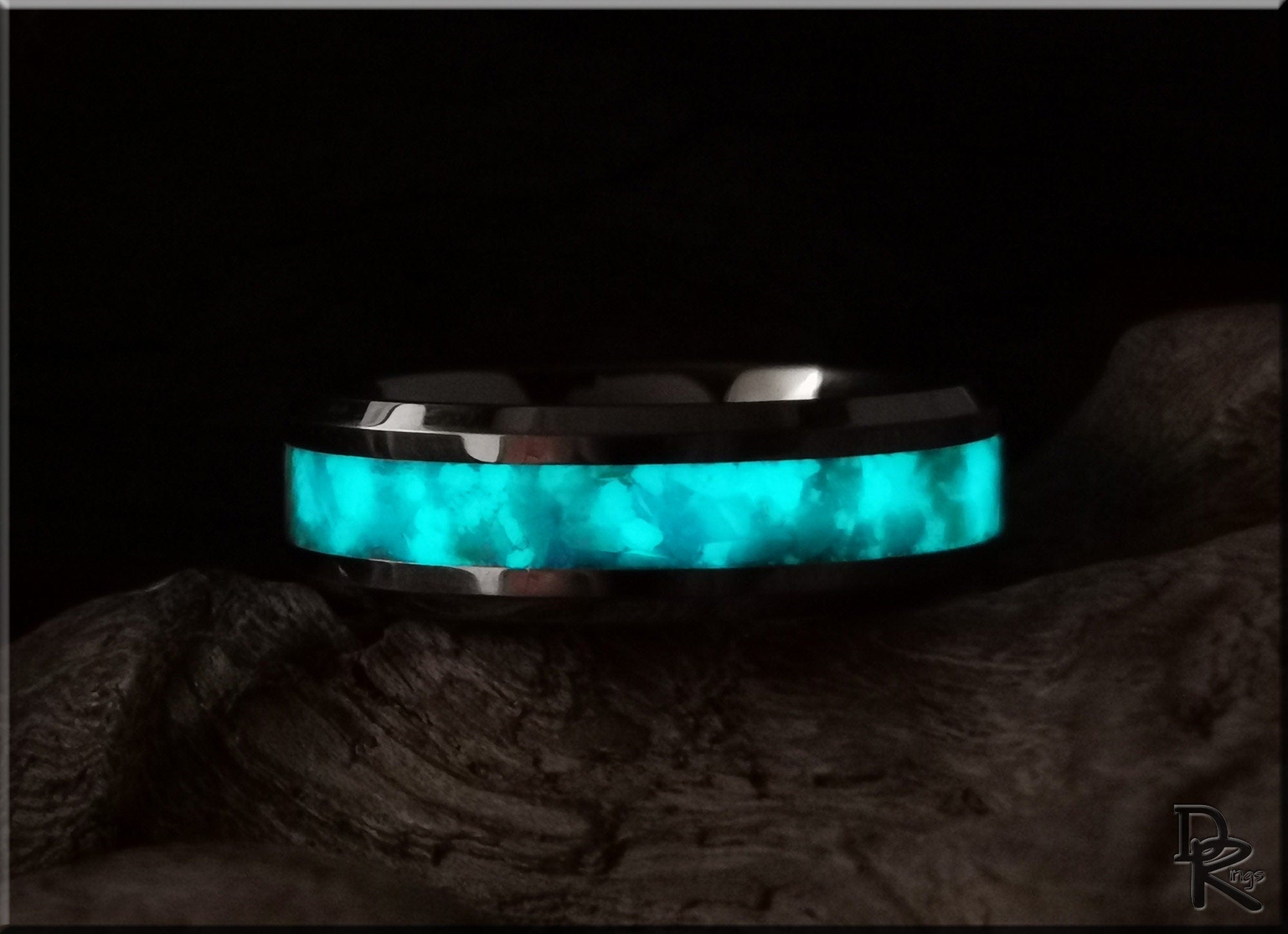 DR Rings tungsten ring with opal and glow featuring bright blue luminescent inlay on dark background