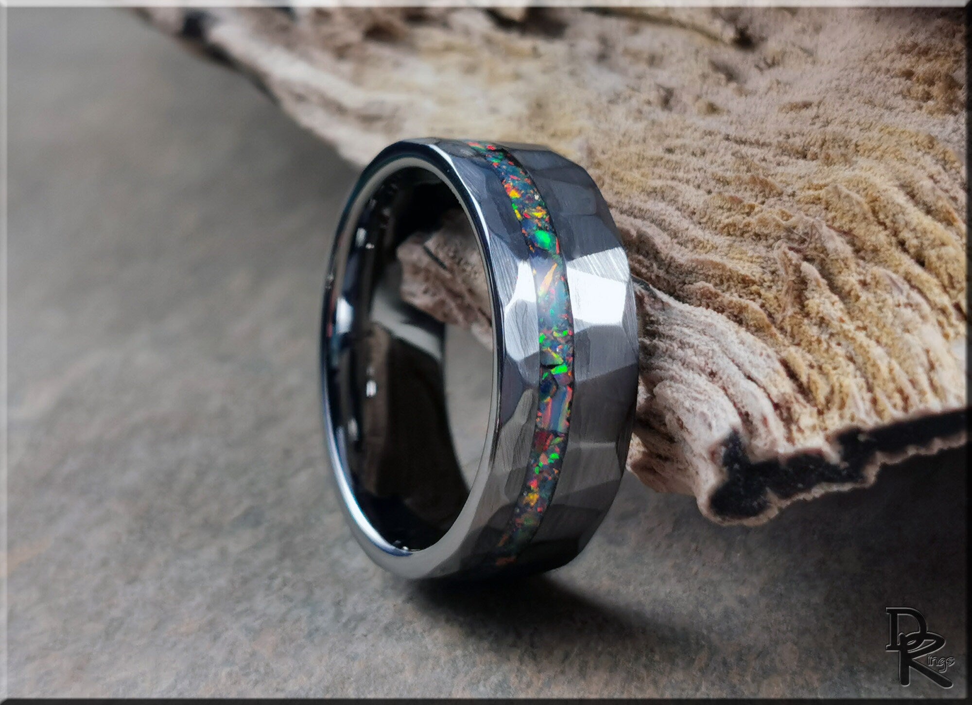 DR Rings tungsten ring with opal inlay featuring a hammered dark metal band and vibrant multicolor opal strip