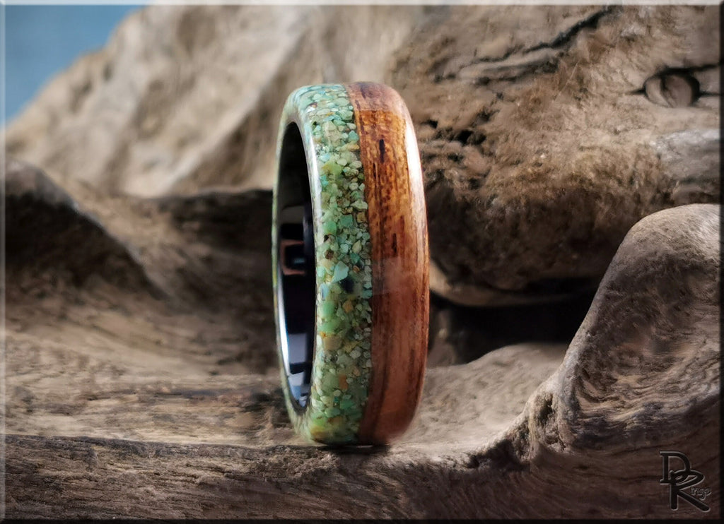 DR Rings close-up of turquoise inlay rings with wood accents on rustic wooden surface