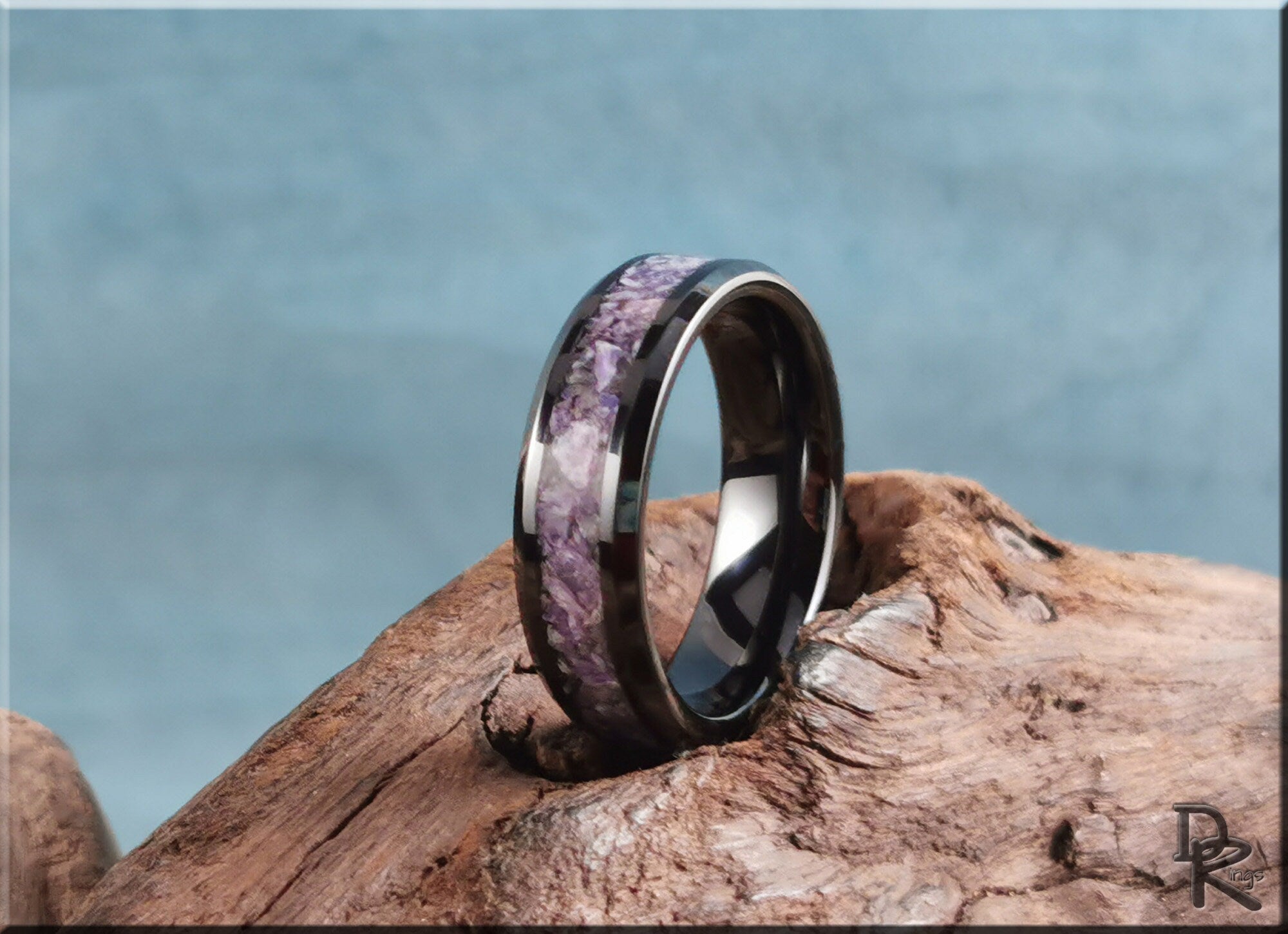 DR Rings ceramic ring with charoite purple stone inlay on wooden surface with blue background