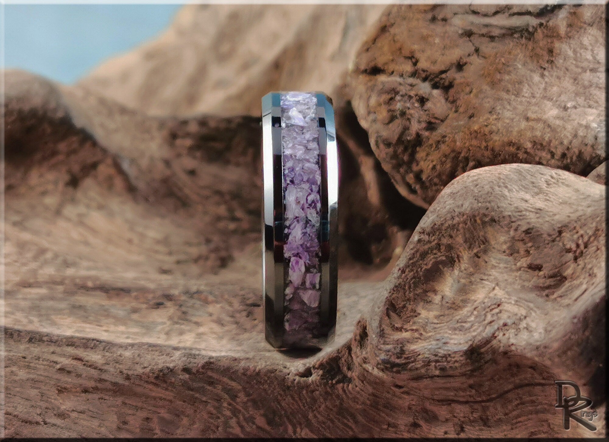 Close-up of a ceramic ring with charoite inlay on a natural wood background by DR Rings