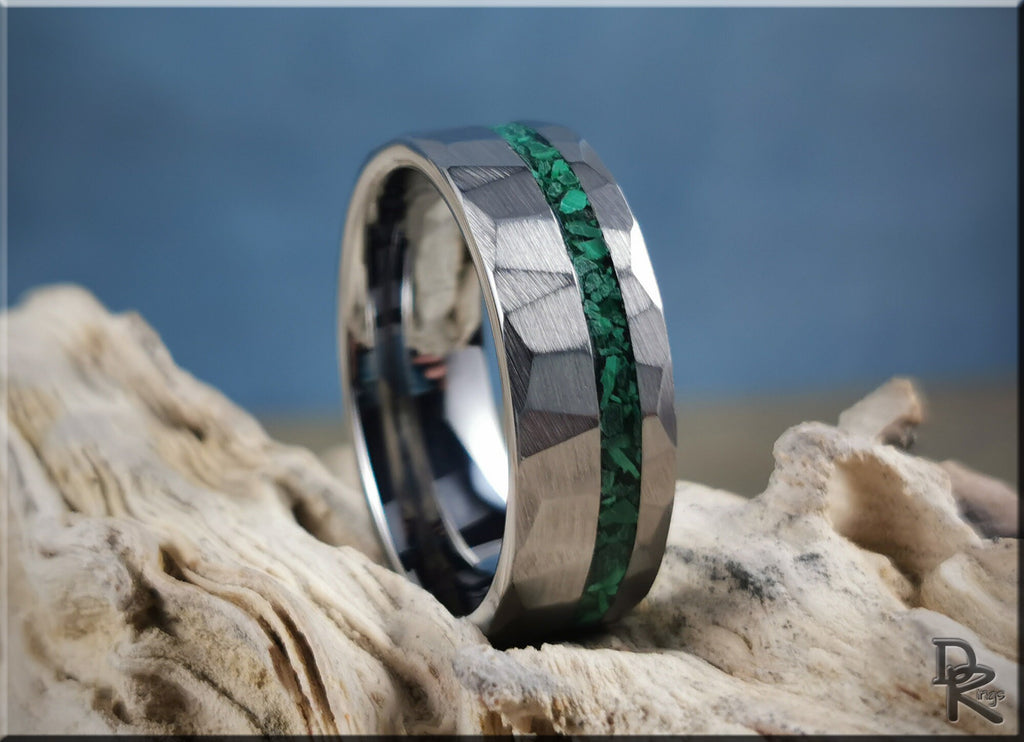Hammered tungsten ring with malachite green inlay on textured wooden surface by DR Rings
