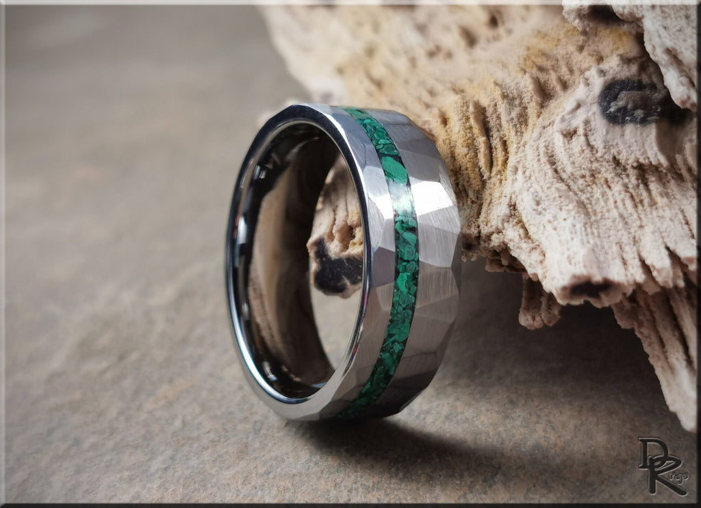 Hammered tungsten ring with malachite inlay by DR Rings on a stone surface