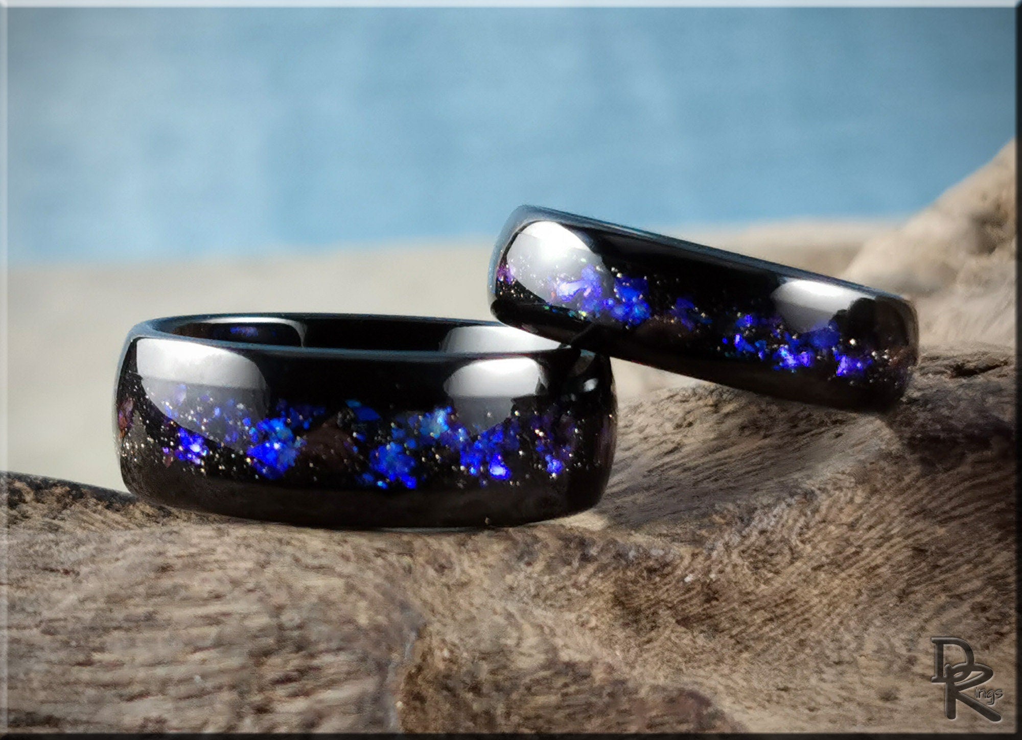 DR Rings black tungsten as a ring with blue opal inlay on natural wood surface