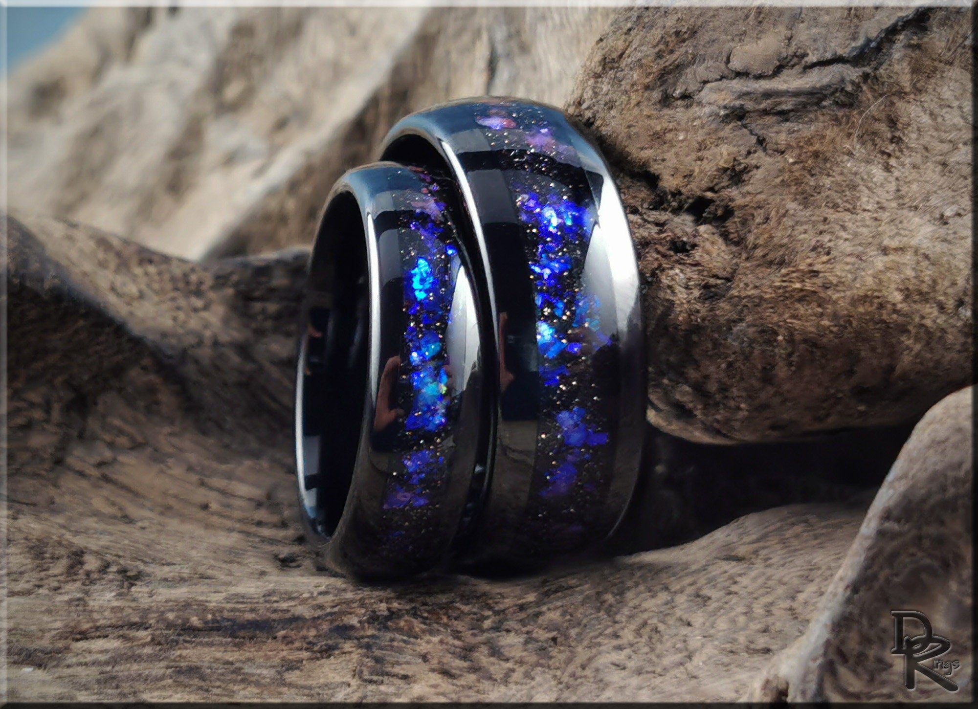 DR Rings blue and black glitter inlay tungsten as a ring set displayed on textured wood
