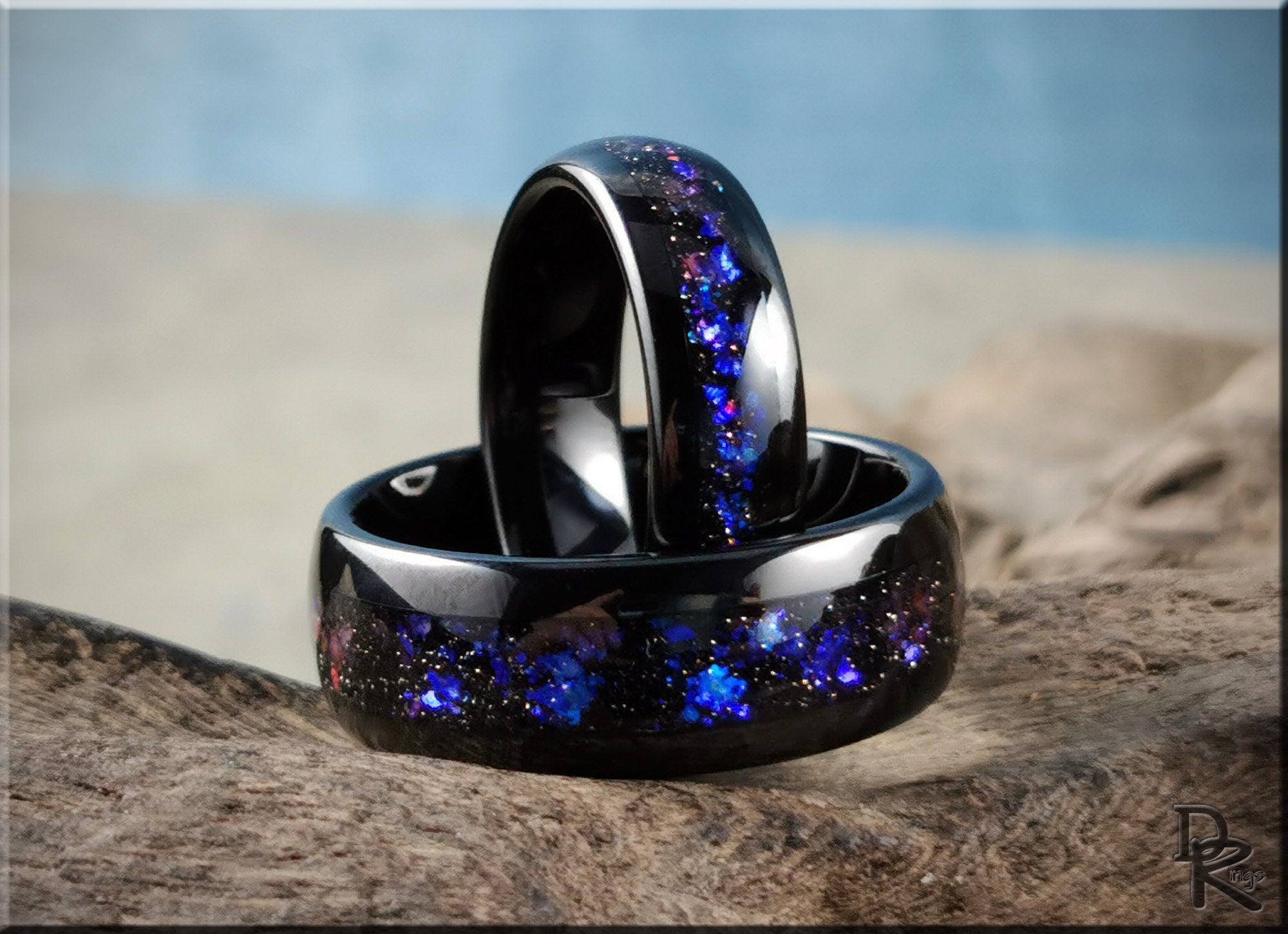 DR Rings black tungsten as a ring with blue and purple galaxy-inspired inlay on rustic wood