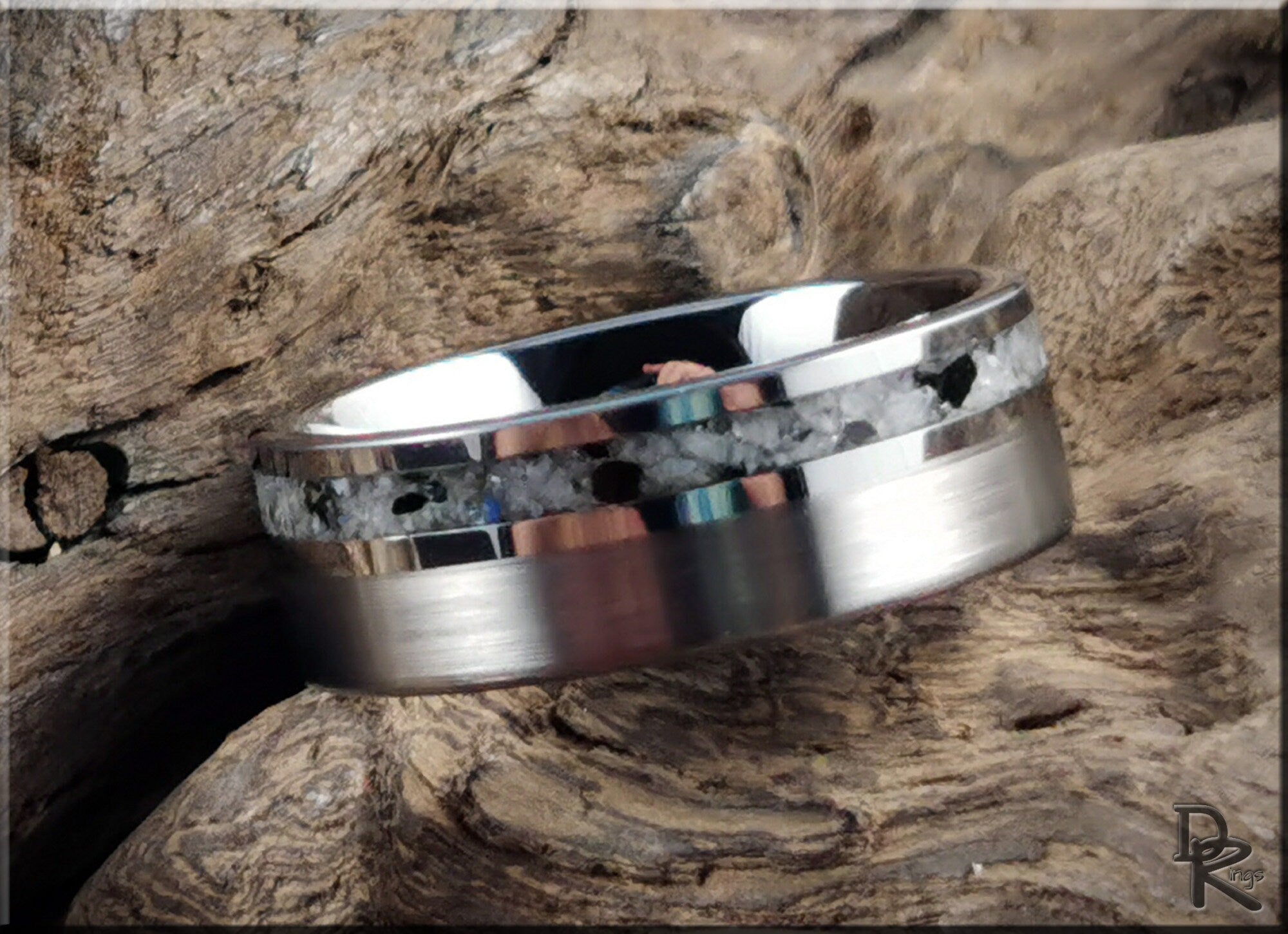 Tungsten carbide ring with moonstone inlay displayed on rustic wooden background by DR Rings