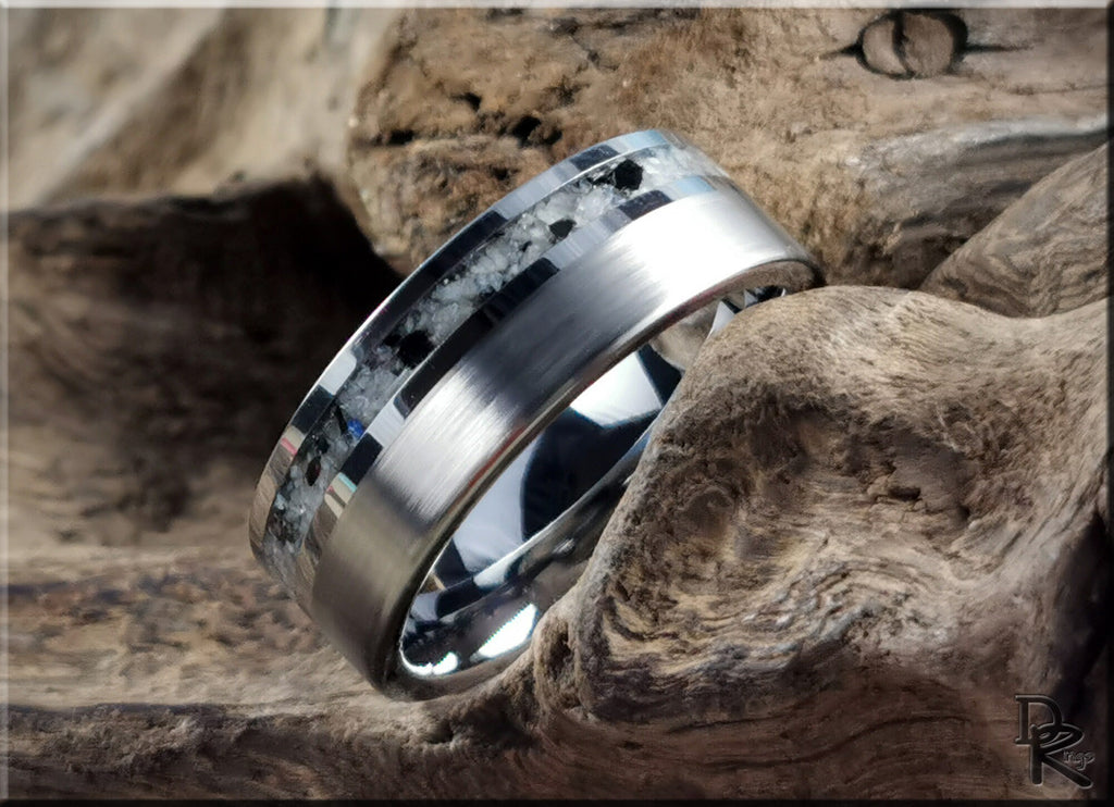 DR Rings tungsten carbide ring with moonstone inlay resting on rustic wood surface