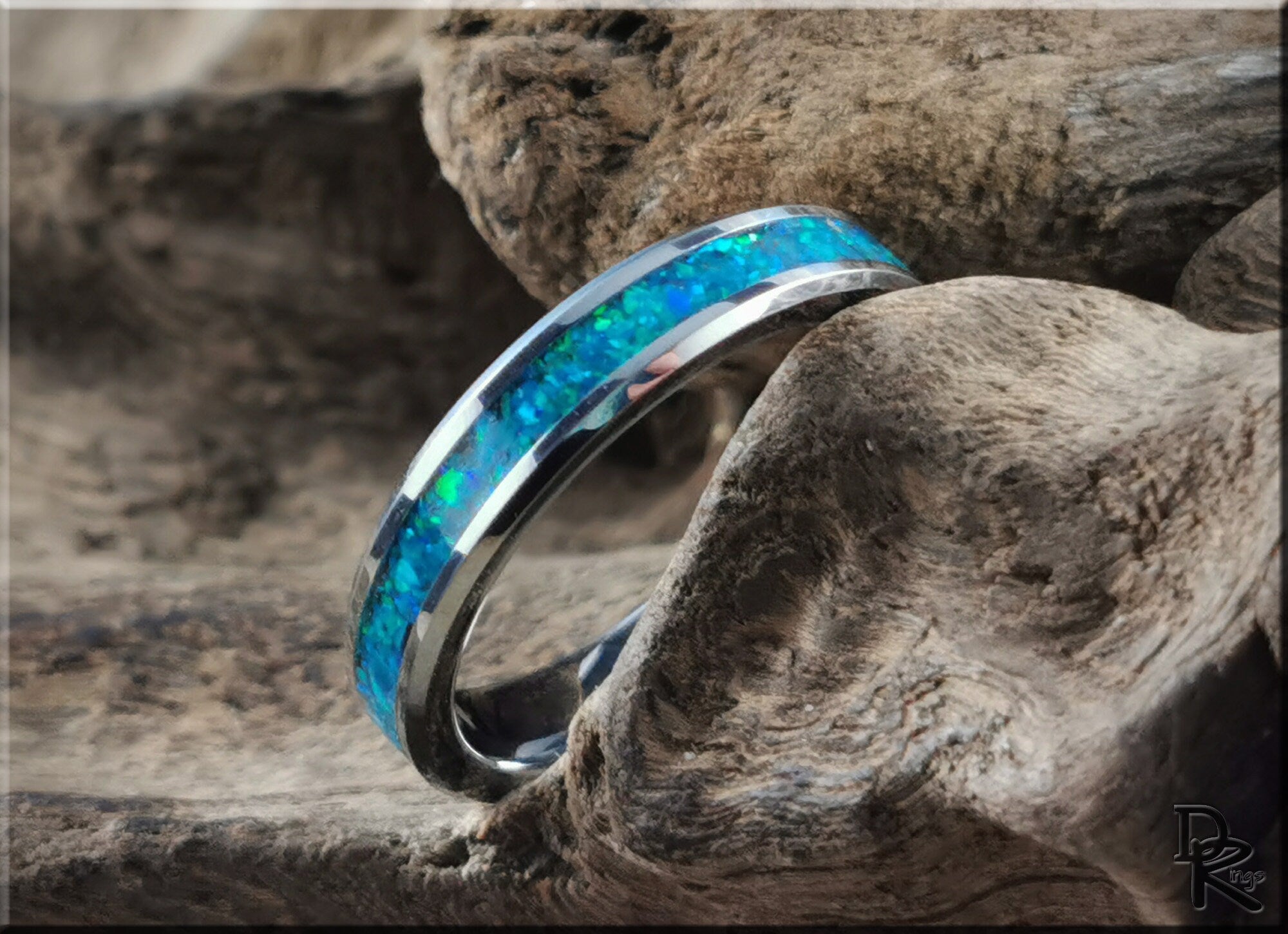 Tungsten carbide ring with opal inlay featuring vibrant blue and green colors from DR Rings