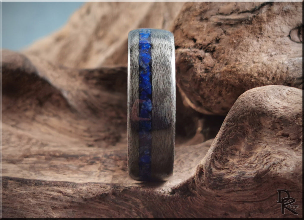 DR Rings wooden band with inlaid lazuli lapis stone strip on textured wood background
