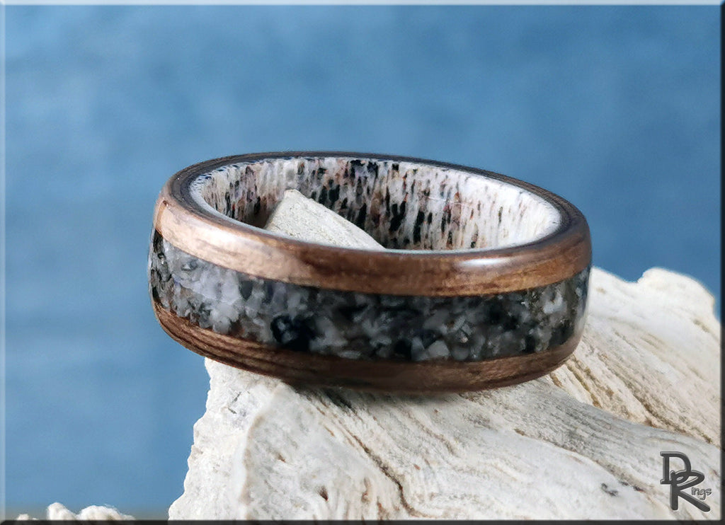 Walnut wood ring with with inlay on antler core featuring dark stone center and polished finish by DR Rings