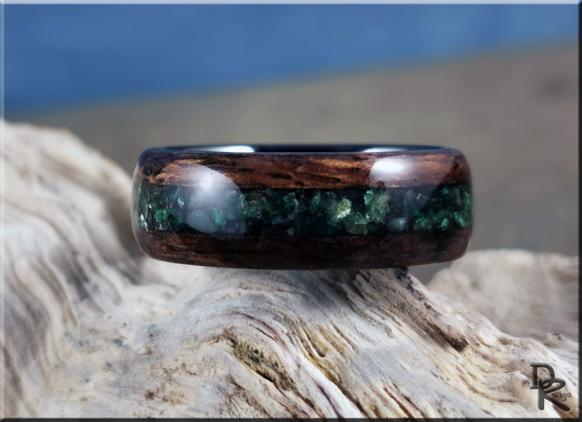 DR Rings wood ring with inlay featuring dark wood and green stone inlay on textured surface