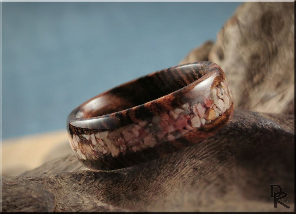 Close-up of a DR Rings wood ring with inlay featuring a mix of natural colors and smooth polished finish