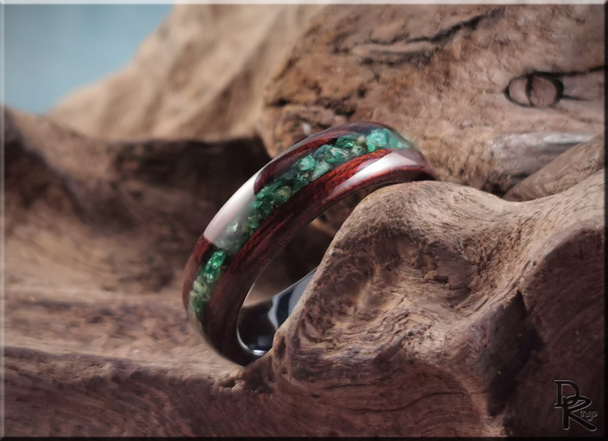 Wood ring with inlay featuring green stone set in polished dark wood band by DR Rings